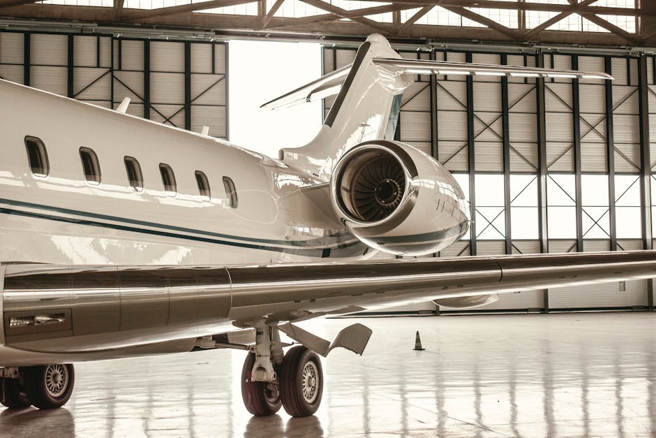 Private jet parked inside modern hangar