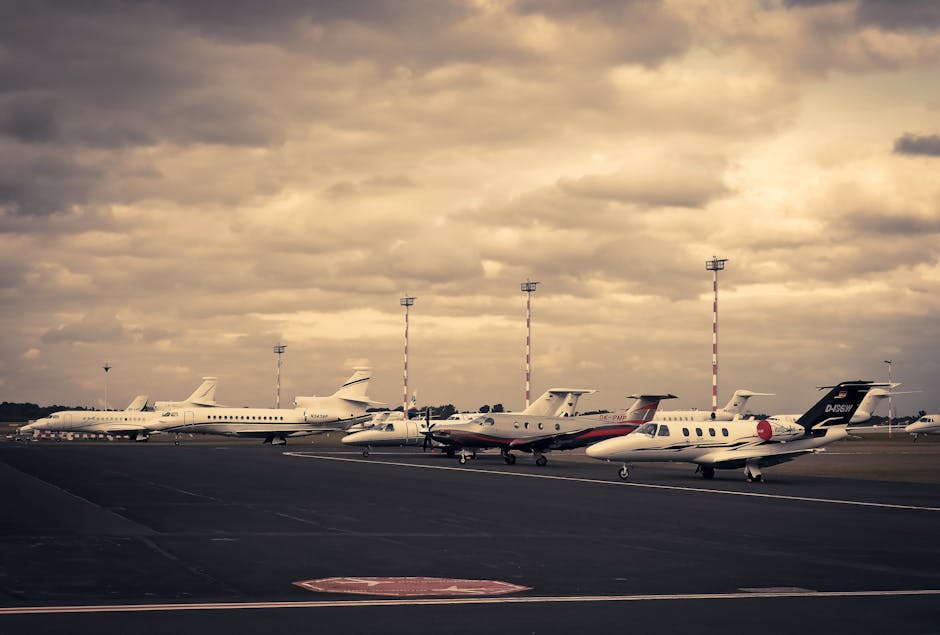 Private jets parked on tarmac under dramatic sky